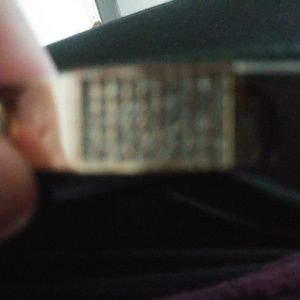 A gold colored braclet with jewles